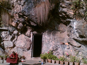 Entrance to Asura Cave with Tibetan Buddhist Monk.