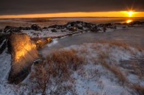 Sunset over the rocky coastline of Hudson Bay, Churchill, Manitoba, Canada.